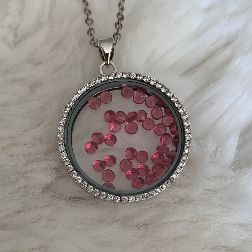 Necklace with stones inside round glass pendant